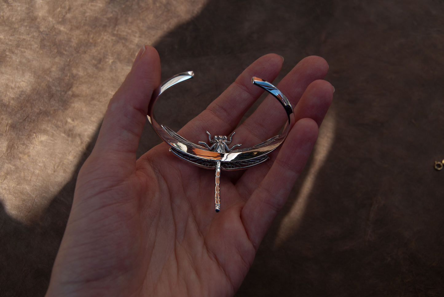 Back side of Silver Dragonfly Bracelet, showing clasp and smooth finish of handcrafted insect jewelry.
