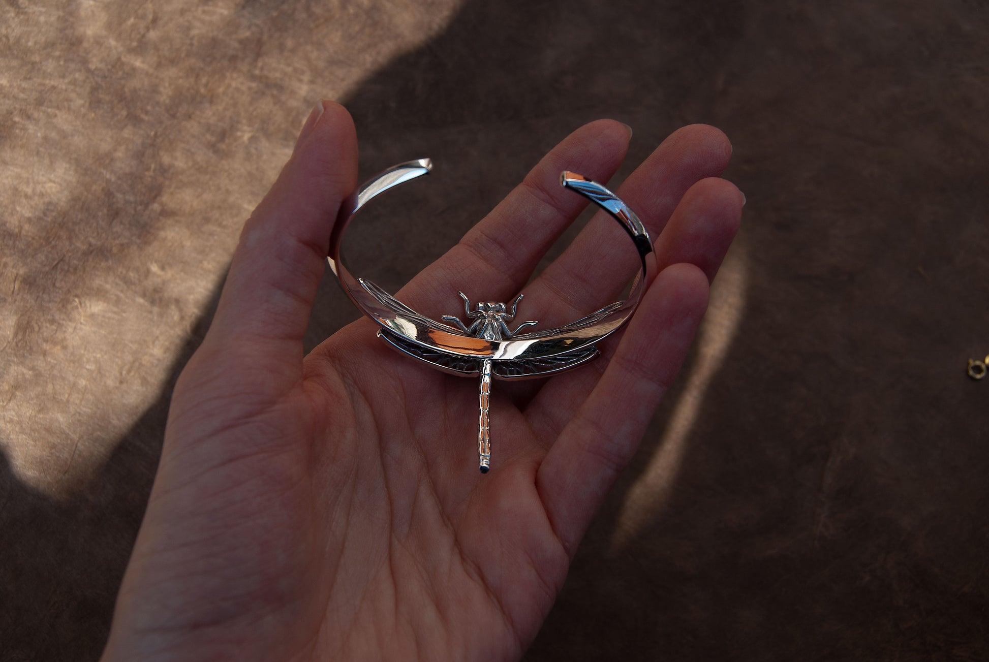 Back side of Silver Dragonfly Bracelet, showing clasp and smooth finish of handcrafted insect jewelry.