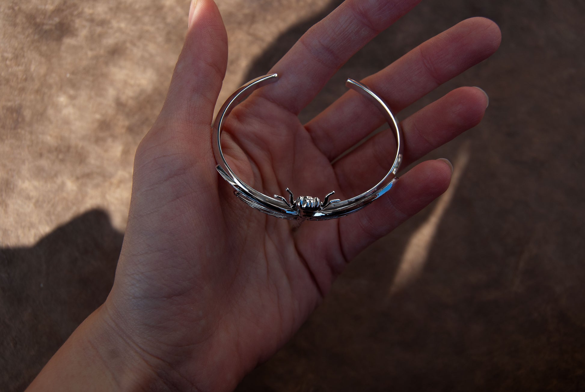 Top view of Silver Dragonfly Bracelet, highlighting symmetrical wing design and polished surface.